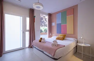 a bedroom with a bed and a large window at Osito Hub - l'Explorador Andrés in Valencia