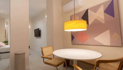 a dining room with a white table and a painting at Osito Hub - l'Explorador Andrés in Valencia