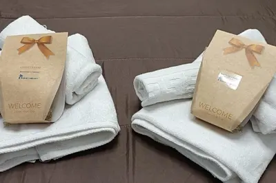 two packages of towels are sitting on top of towels at MalvaLindaBeach Loft Benlliure Malvarrosa/Patacona in Valencia