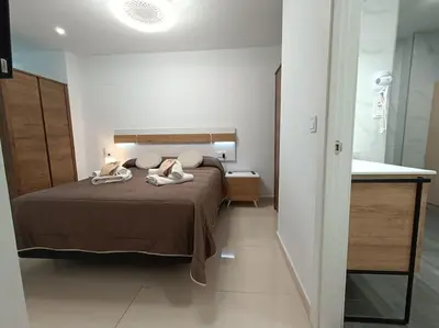 a bedroom with a bed with two towels on it at MalvaLindaBeach Loft Benlliure Malvarrosa/Patacona in Valencia