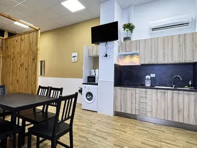 a kitchen and dining room with a table and a sink at Cooperativa 8 in Valencia