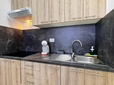 a kitchen with wooden cabinets and a sink and a mixer at Cooperativa 8 in Valencia