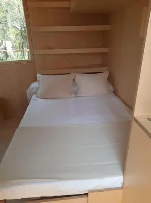 a large white bed in a small room at Calma Villa. Chalet de lujo, jacuzzi y piscina in Valencia