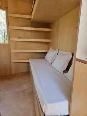 a small bedroom with a bed in a room at Calma Villa. Chalet de lujo, jacuzzi y piscina in Valencia