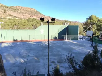 an empty basketball court with a basketball hoop at Calma Villa. Chalet de lujo, jacuzzi y piscina in Valencia
