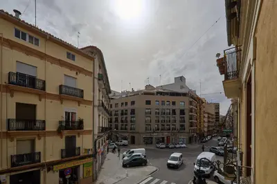 a city street with parked cars and buildings at Apartamento minimalista en Matemático Marzal in Valencia