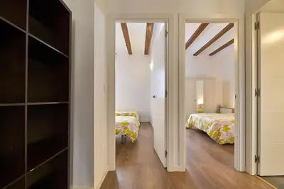 a bedroom with two beds and a closet at Apartamento minimalista en Matemático Marzal in Valencia