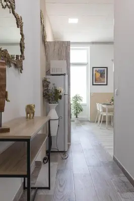a kitchen with a refrigerator in the middle of a room at Malvarrosa Las Arenas Access in Valencia
