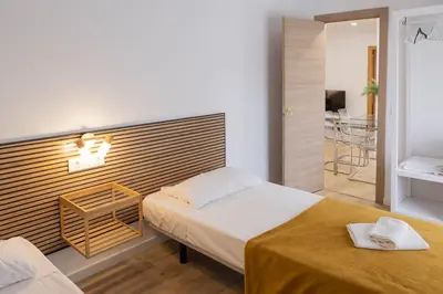 a bedroom with two beds and a walk in shower at Furio Silence in Valencia