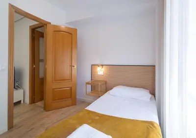 a small bedroom with a bed and a window at Furio Silence in Valencia