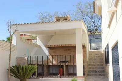 a white house with a balcony with a fence at Sierra de Chiva Villa in Chiva