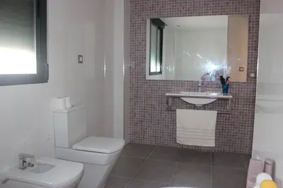 a bathroom with a white toilet and a sink at Sierra de Chiva Villa in Chiva