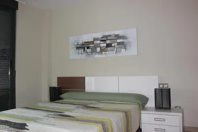 a bedroom with a bed and a painting on the wall at Sierra de Chiva Villa in Chiva