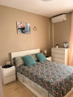 a bedroom with a bed with blue pillows at Cullera Mountain View in Cullera