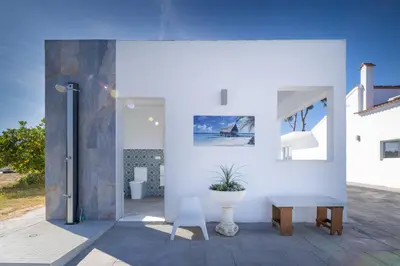 a white room with a bench and a table at La Villa de Luz in Torrent