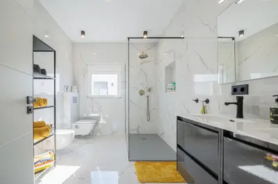 a white bathroom with a shower and a sink at La Villa de Luz in Torrent