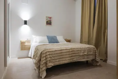a bedroom with a bed with a blanket on it at Non Stress Templo in Valencia