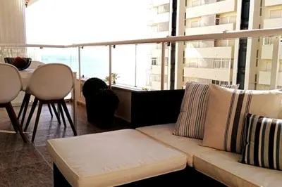 a living room with a couch and a table at Apartamento frente al mar in Cullera
