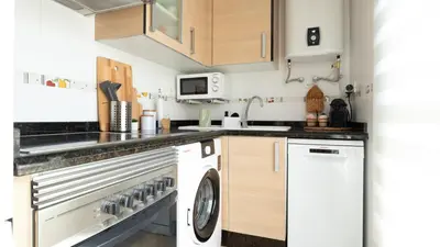 a kitchen with a dishwasher and a washer and dryer at Tú & Yo Moncofa in Moncófar