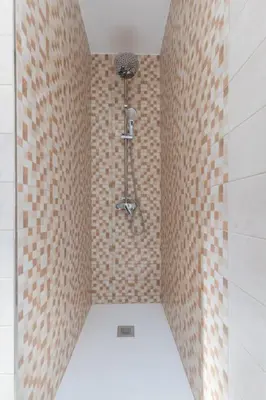 a bathroom with a shower with a brick wall at Placid Puerto in Puerto de Sagunto