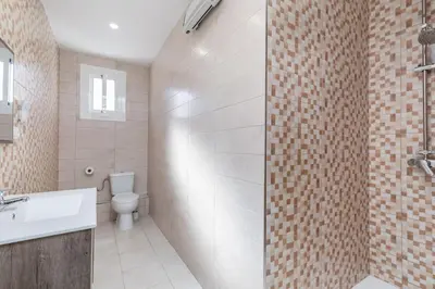a bathroom with a toilet and a sink and a shower at Placid Puerto in Puerto de Sagunto