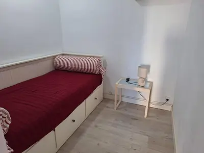 a small bedroom with a bed and a table at Cullera Playa in Cullera