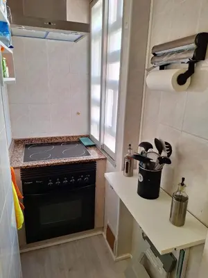 a small kitchen with a stove and a counter at Cullera Playa in Cullera