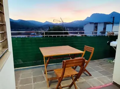 a patio with a couch and an umbrella at Ca La Perla in Albalat de Taronchers