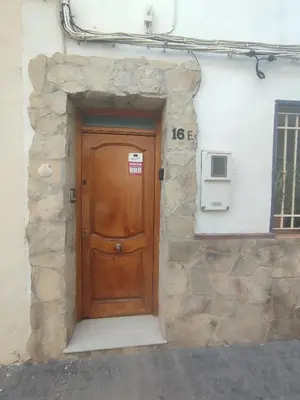 a wooden door on the side of a building at Ca La Perla in Albalat de Taronchers