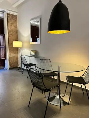 a dining room with a glass table and chairs at Apartamento chic en Ciutat Vella in Valencia