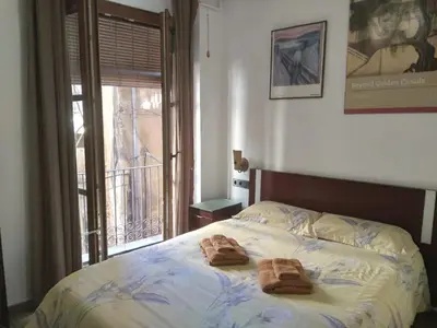 a bedroom with a bed with two towels on it at Valencia Centro Suite in Valencia