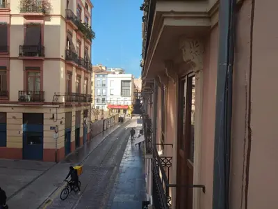 a person riding a bike on a street next to a building at Valencia Centro Suite in Valencia