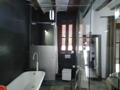a bathroom with a bath tub and a toilet at Valencia Centro Suite in Valencia