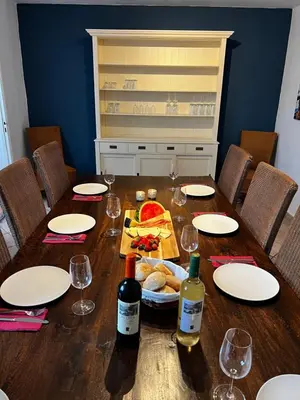 a table with wine bottles and a plate of food at Casa el Girasol, rustig gelegen kindvriendelijke villa 10 p in Montroy