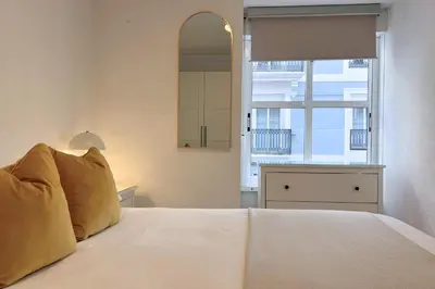 a bedroom with a white bed with a window at Encanto exclusivo en pleno centro de Valencia in Valencia