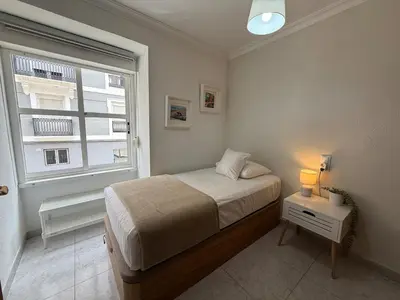 a small bedroom with a bed and a window at Encanto exclusivo en pleno centro de Valencia in Valencia