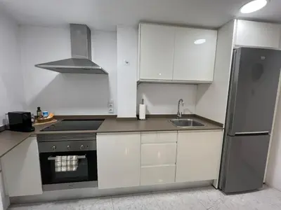 a kitchen with white cabinets and a stainless steel refrigerator at Encanto exclusivo en pleno centro de Valencia in Valencia
