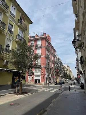 an empty city street with a tall red building at Encanto exclusivo en pleno centro de Valencia in Valencia