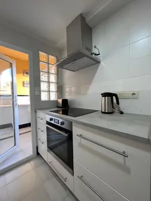 a kitchen with a stove and a pot on the counter at Cap Blanc Apartment with Sea View and Beach in Cullera