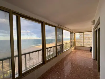 a room with windows and a view of the beach at Apto. Cullera vistas espectaculares primera línea in Cullera
