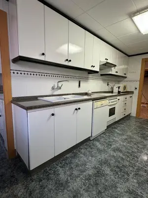 a kitchen with white cabinets and a sink at Apto. Cullera vistas espectaculares primera línea in Cullera