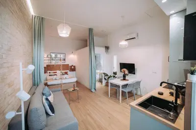 a living room with a couch and a table at Acogedor loft en Cabañal playa Malvarosa in Valencia
