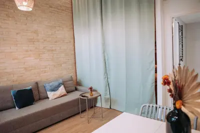 a living room with a couch and a brick wall at Acogedor loft en Cabañal playa Malvarosa in Valencia