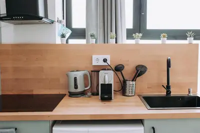 a kitchen counter with a coffee maker and utensils at Acogedor loft en Cabañal playa Malvarosa in Valencia