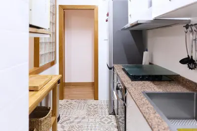 a small kitchen with a counter top and a sink at Apartamento pobla farnals playa precioso in Las Canteras