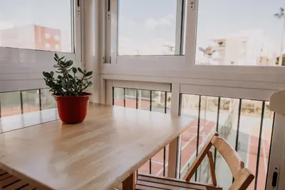 a wooden table with a potted plant on top of it at Apartamento pobla farnals playa precioso in Las Canteras