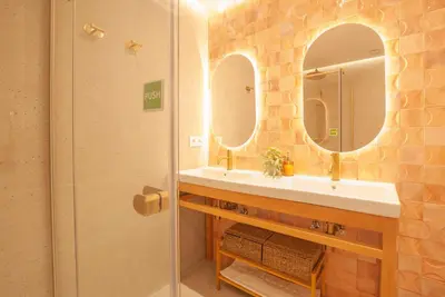 a bathroom with a sink and two mirrors at Estudio Bohemio Centro in Valencia