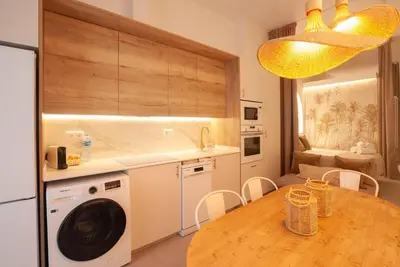 a kitchen with a table and a washing machine at Estudio Bohemio Centro in Valencia
