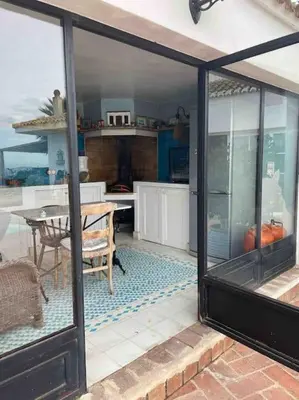 a kitchen with a large glass door and a table at Agradable Casa con maravillosas vistas in Chiva