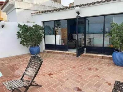 a chair sitting on a brick patio in front of a house at Agradable Casa con maravillosas vistas in Chiva